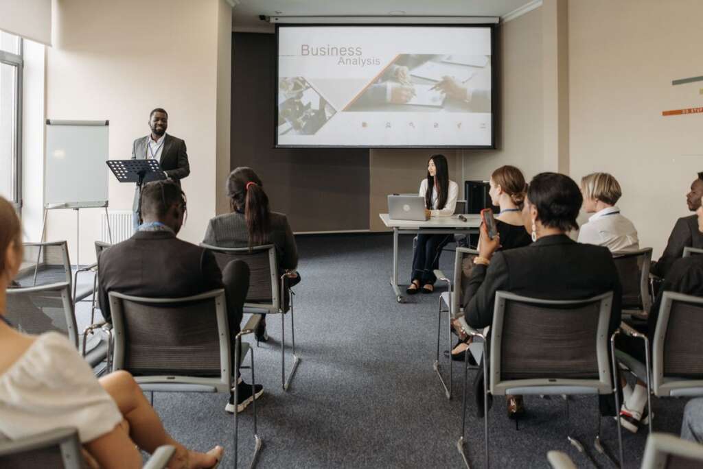 Speaker presenting at a podium to an audience