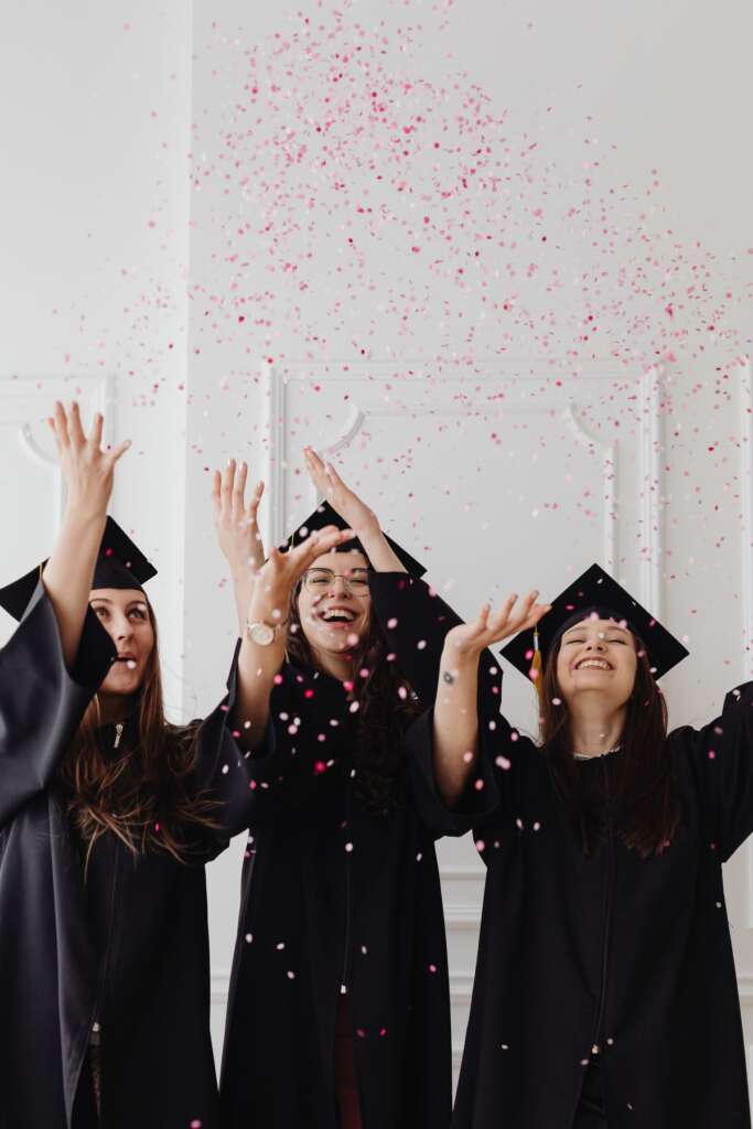 Graduates tossing confetti in celebration