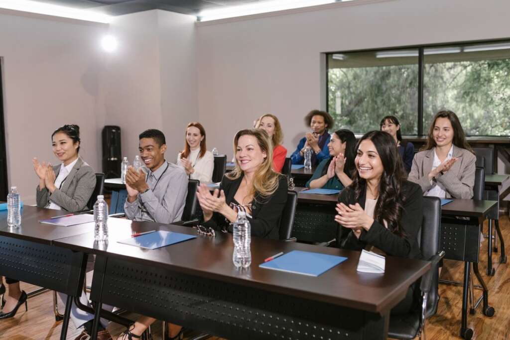 Audience applauding at a community meeting