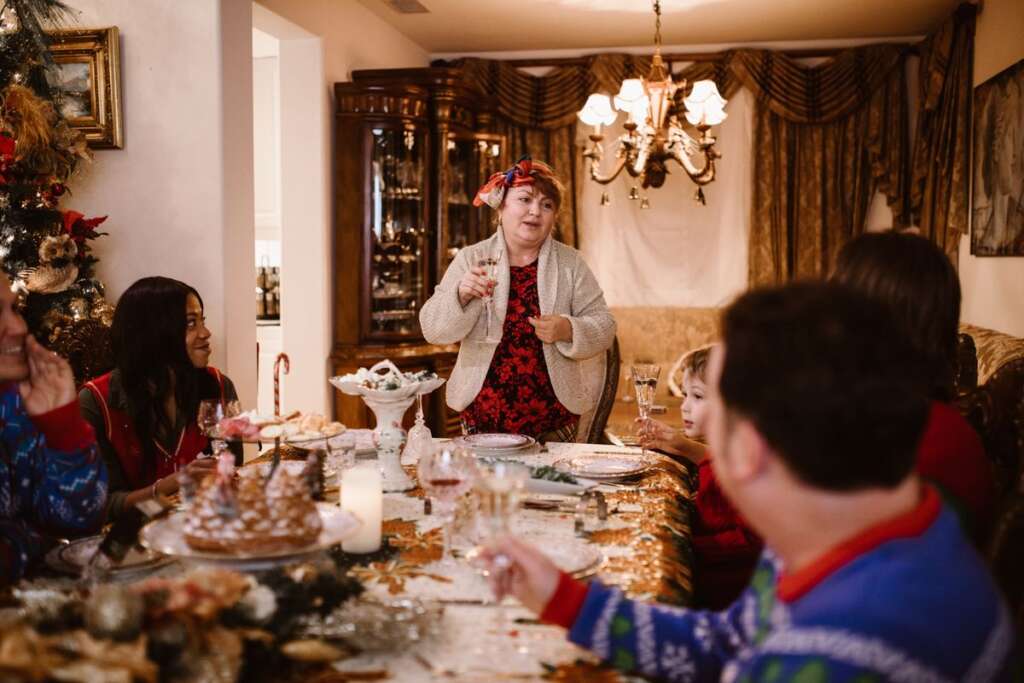 Family gathered around a festive holiday table